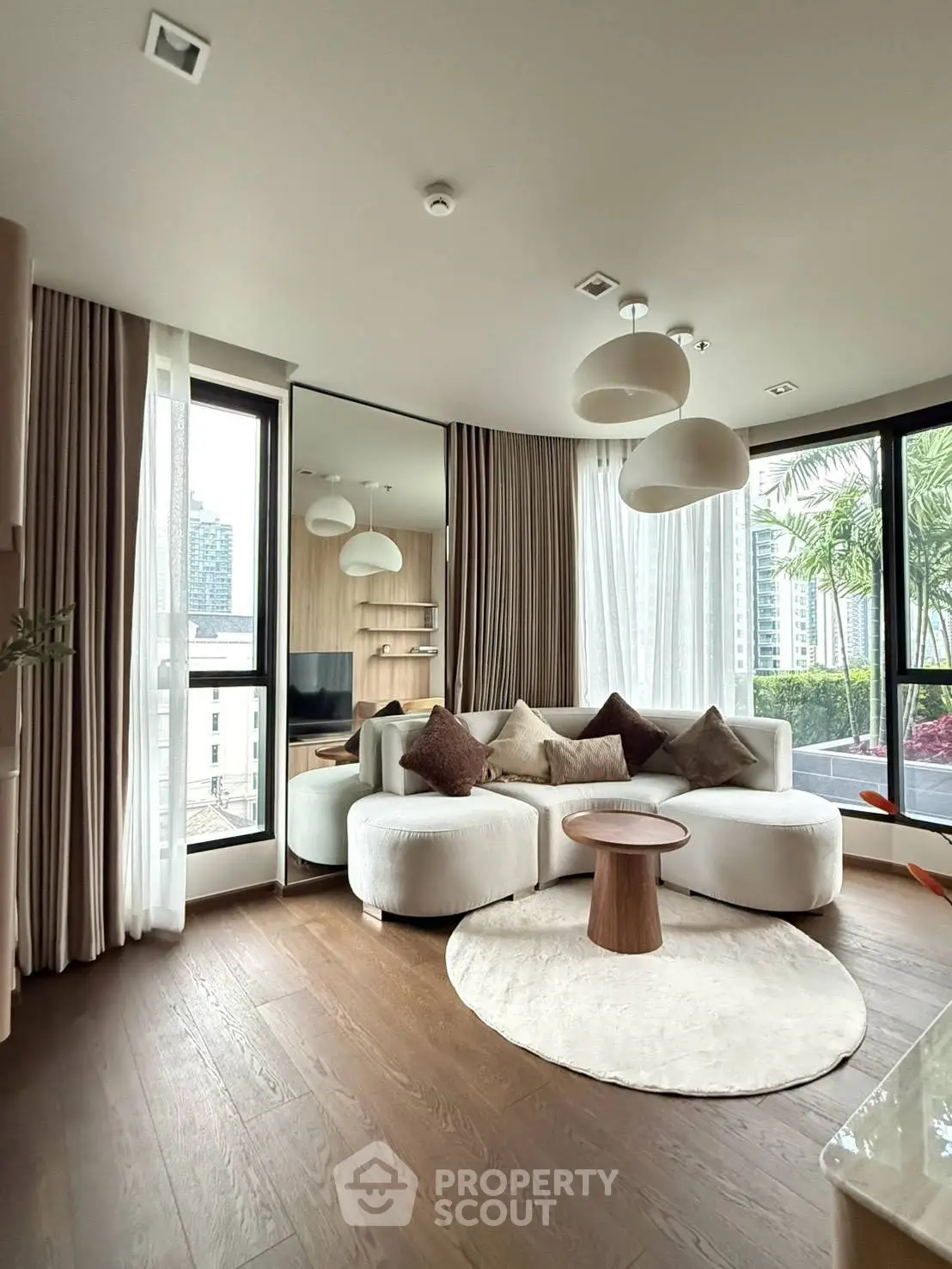 Luxurious modern living room with large windows and elegant decor