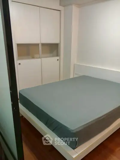 Cozy bedroom with modern design and built-in wardrobe