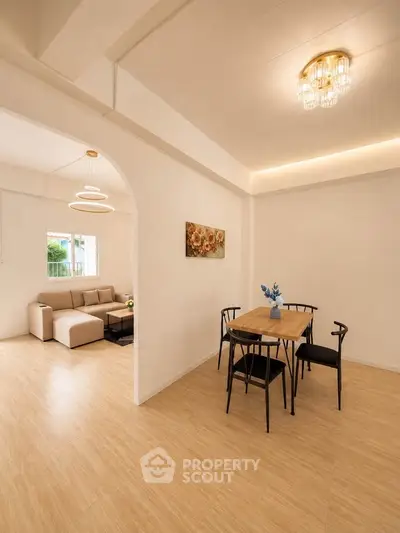 Spacious open-plan living and dining area with modern decor and natural light.