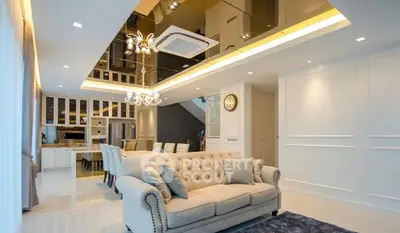 Luxurious living room with elegant chandelier and plush sofa in modern open layout.