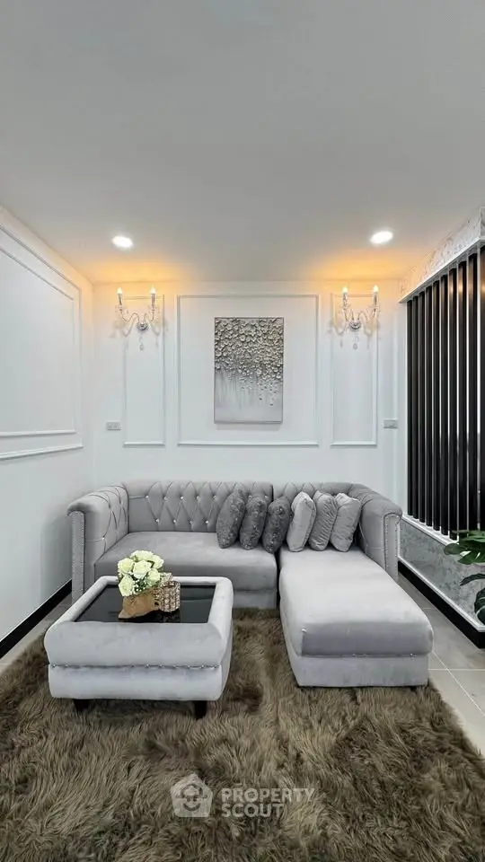 Elegant living room with plush gray sofa and chic decor