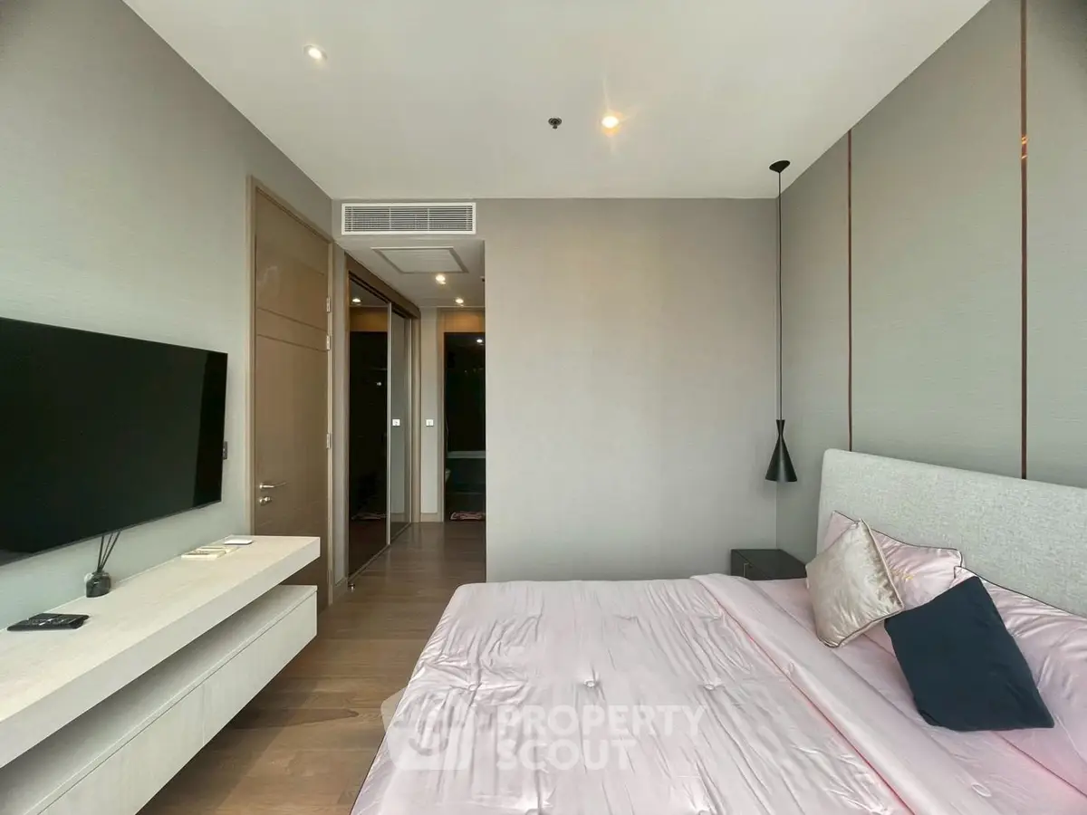 Modern bedroom with sleek design and wall-mounted TV