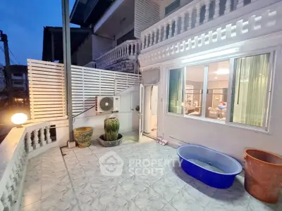 Charming townhouse balcony with tiled flooring and cozy outdoor setup