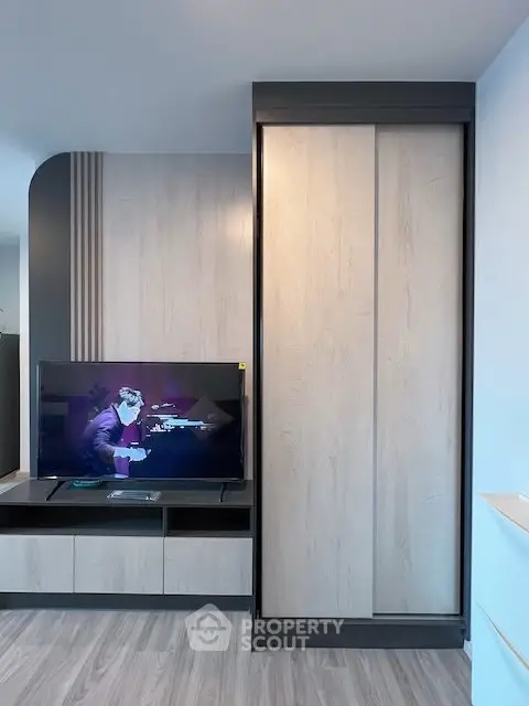 Modern living room with sleek TV unit and stylish wooden paneling