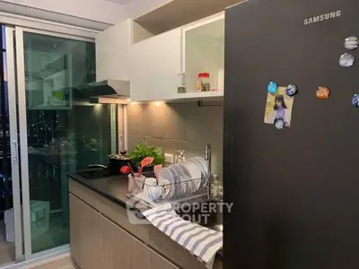Modern kitchen with sleek cabinets, Samsung fridge, and open layout for stylish living.