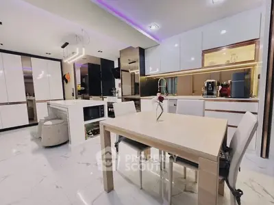 Modern kitchen with sleek white cabinets and dining area, featuring ambient lighting and marble flooring.