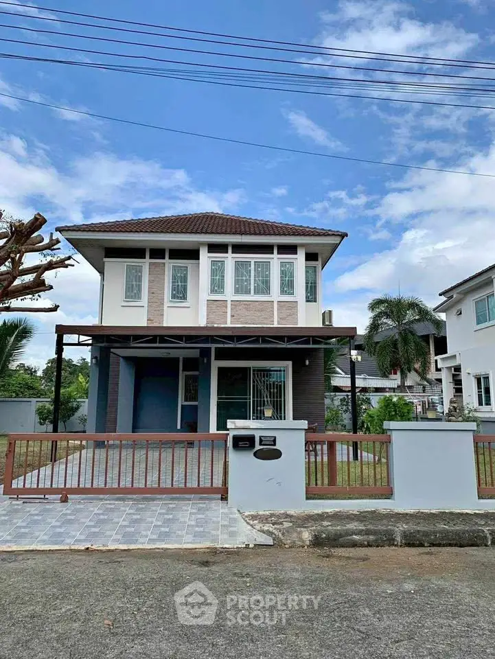 Charming two-story house with modern design and spacious front yard in a serene neighborhood.