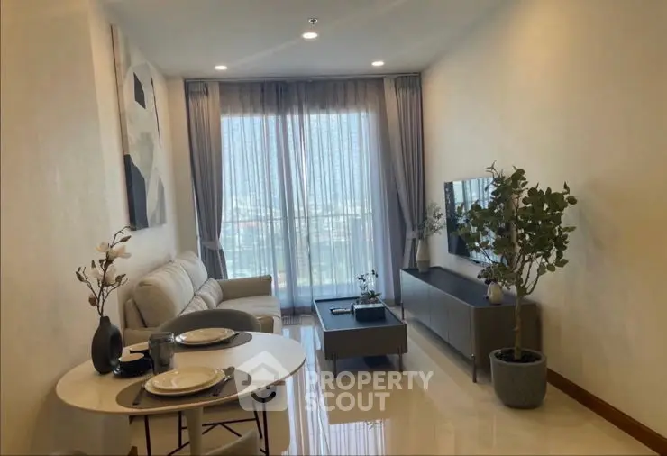 Modern living room with elegant decor and large windows offering natural light.