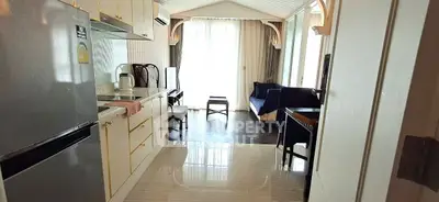 Chic modern kitchen with open layout leading to a cozy living area, perfect for urban living.