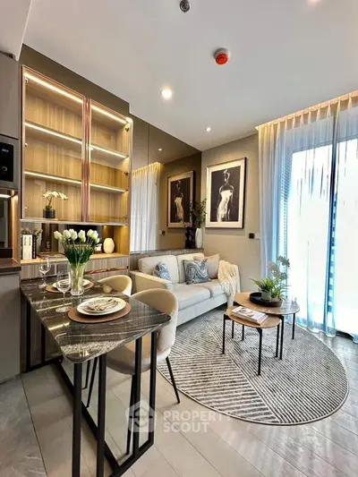 Modern living room with elegant decor and open layout, featuring a cozy sofa and stylish dining area.