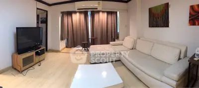 Spacious living room with modern furniture and large TV, perfect for relaxation.