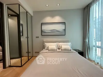 Elegant bedroom with a large comfortable bed, soft lighting, and modern decor, featuring a full-length mirror and serene artwork.