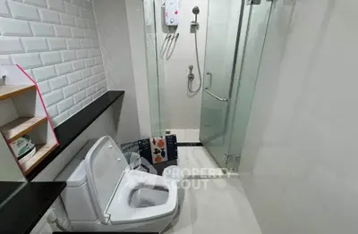 Modern bathroom with glass shower and sleek white tiles