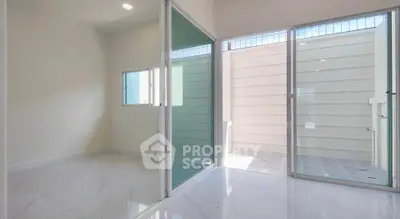 Modern interior with sliding glass doors and sleek tile flooring