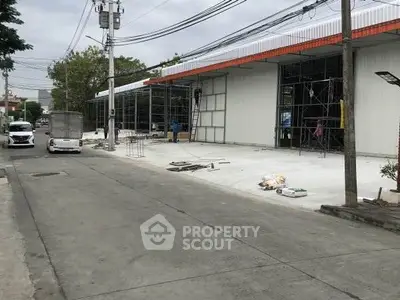 Commercial building under construction with scaffolding and street view