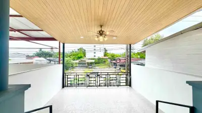 Spacious balcony with ceiling fan and scenic view, perfect for relaxation and outdoor enjoyment.