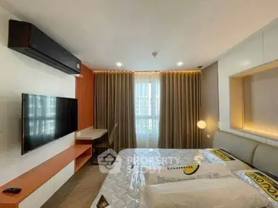 Modern bedroom with stylish decor, large TV, and cozy lighting for ultimate comfort.