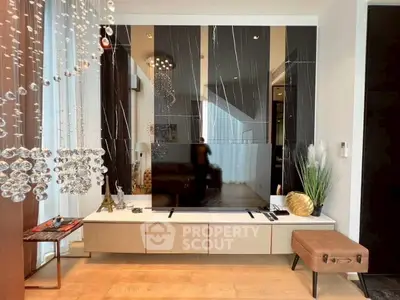 Luxurious living room with modern decor and large TV setup