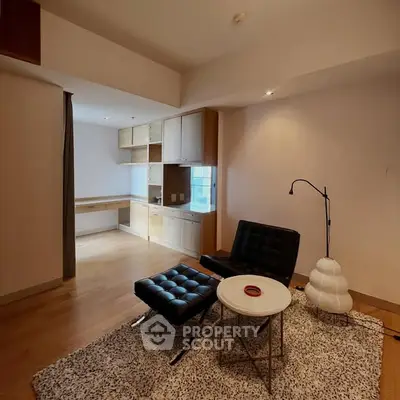 Stylish living room with modern furniture and open kitchen layout