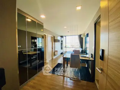 Modern apartment interior with sleek design and open layout, featuring a dining area and large windows.