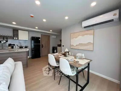 Modern open-plan living room and kitchen with stylish dining area and contemporary decor.