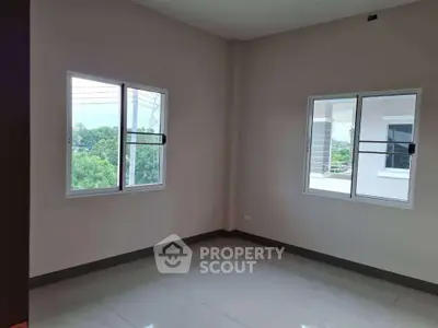 Bright empty room with large windows and glossy floor tiles, perfect for customization.
