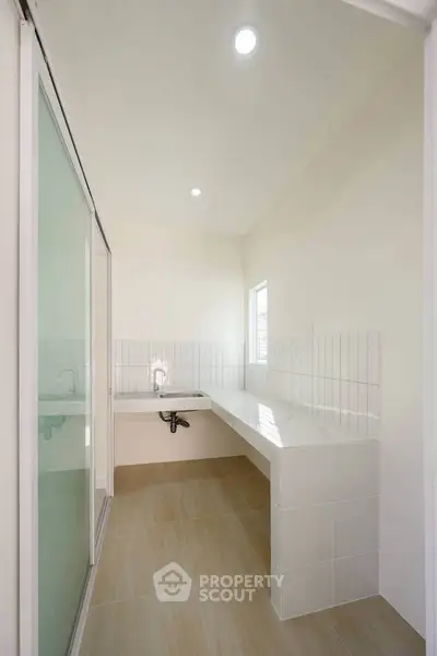 Modern minimalist bathroom with sleek white tiles and spacious layout
