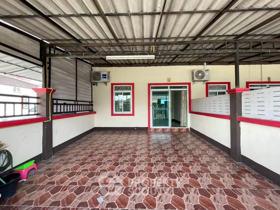 Spacious covered patio with tiled flooring and air conditioning units