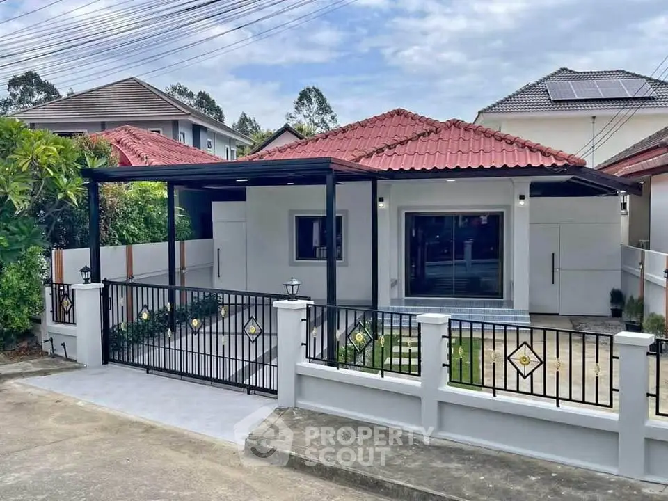 Charming single-story house with red tile roof and modern gated entrance in a serene neighborhood.