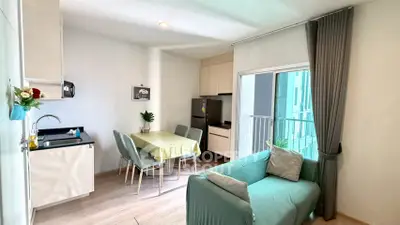Modern living room with open kitchen and balcony in a stylish apartment