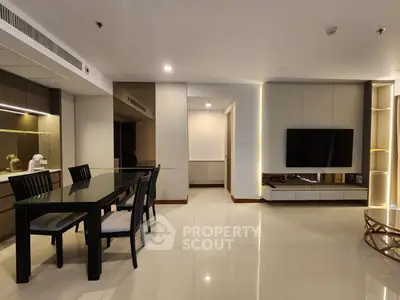 Modern living room with sleek dining area and wall-mounted TV
