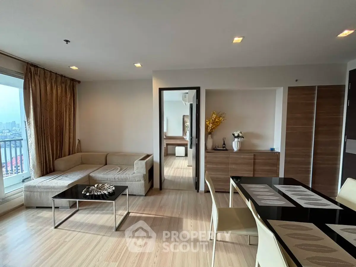 Spacious modern living room with elegant dining area and city view balcony