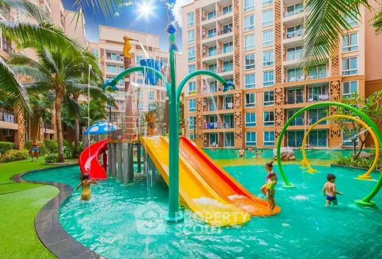 Vibrant residential complex with colorful water playground and lush greenery.