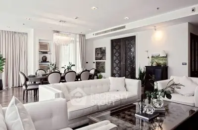 Luxurious open-plan living and dining area with elegant decor and plush seating.