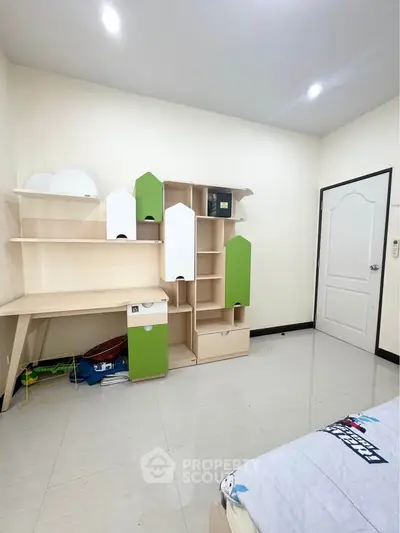 Modern bedroom with sleek storage and study area, perfect for a stylish and organized living space.