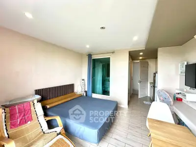 Spacious bedroom with modern decor and natural light, featuring a comfortable bed and stylish furnishings.