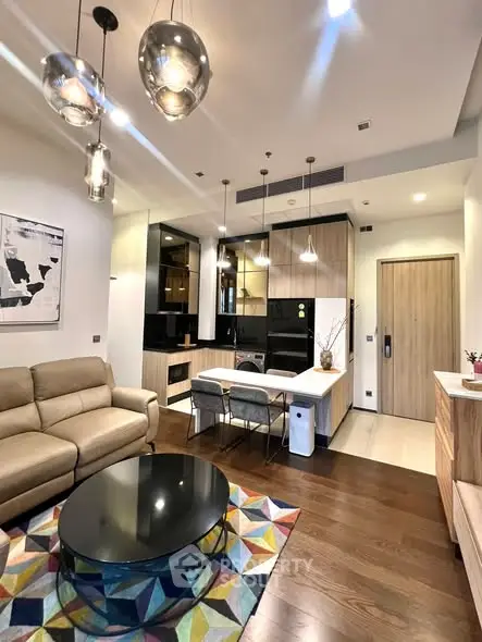 Modern open-plan living room with stylish kitchen and cozy seating area.