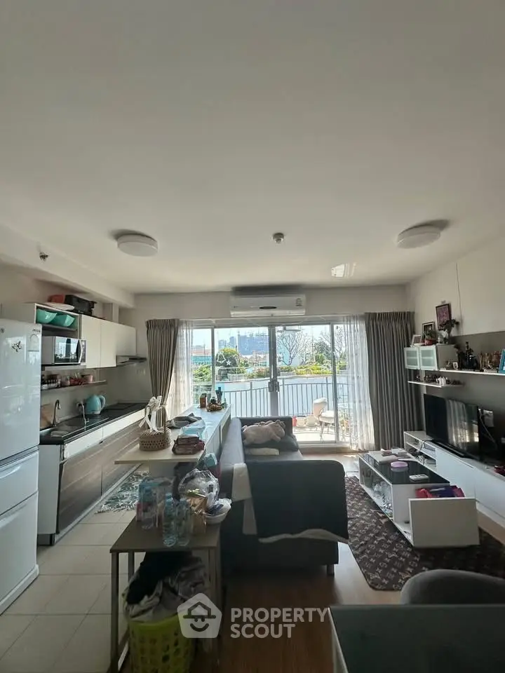 Spacious open-layout living room with balcony and scenic view