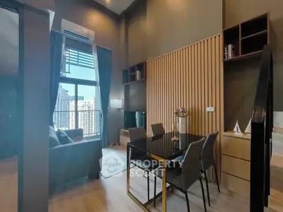 Modern living room with high ceiling and large window offering city view, featuring elegant dining area and stylish decor.