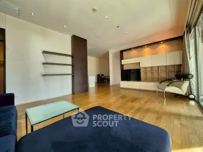 Spacious modern living room with wooden flooring and stylish furniture