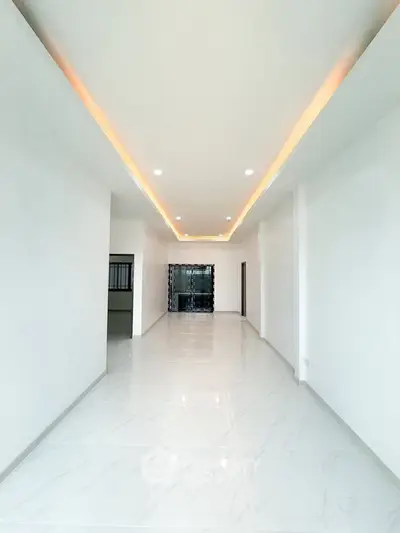 Spacious modern living room with elegant lighting and marble flooring