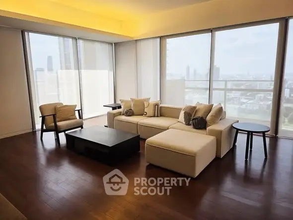 Luxurious living room with panoramic city view and elegant furnishings.