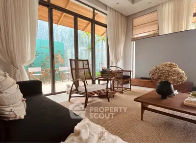 Charming living room with natural light, elegant decor, and garden view, perfect for relaxation and entertaining.
