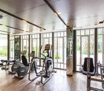 Modern gym with state-of-the-art equipment and large windows for natural light.