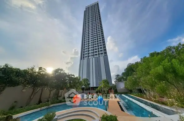 Stunning high-rise building with pool and lush greenery, perfect for luxury living.