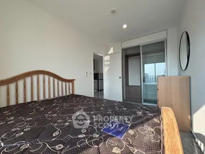 Spacious bedroom with elegant wooden bed and ample natural light in modern apartment.