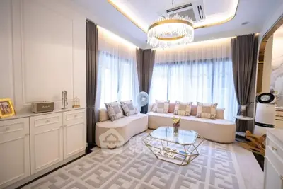 Luxurious living room with elegant chandelier and stylish furniture in modern apartment.