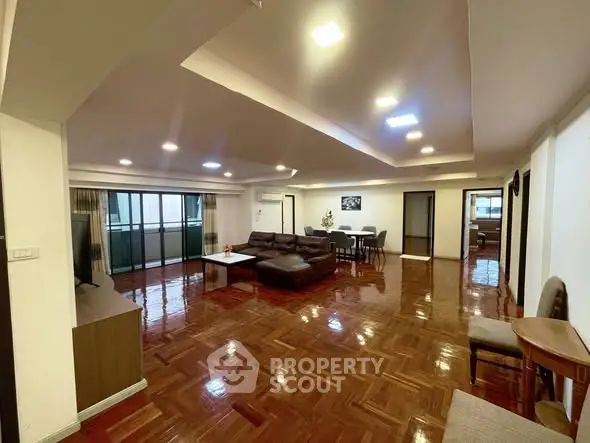 Spacious living room with polished wooden floors and modern furniture