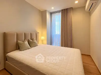 Elegant bedroom with plush bed, soft lighting, and modern decor in a cozy apartment.