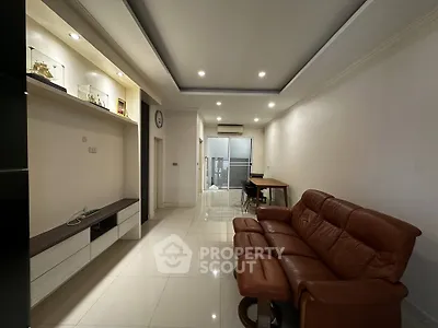 Spacious living room with modern furniture and sleek design, perfect for relaxation and entertainment.